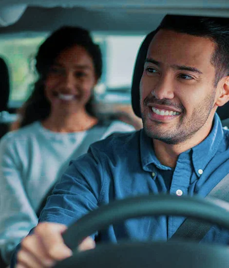 A friendly and professional taxi cab driver greeting a passenger.