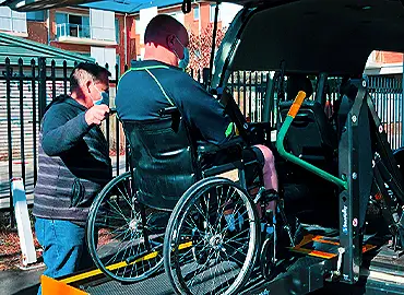 A courteous taxi cab driver, yielding to pedestrians.