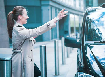  A friendly and professional taxi cab driver greeting a passenger.